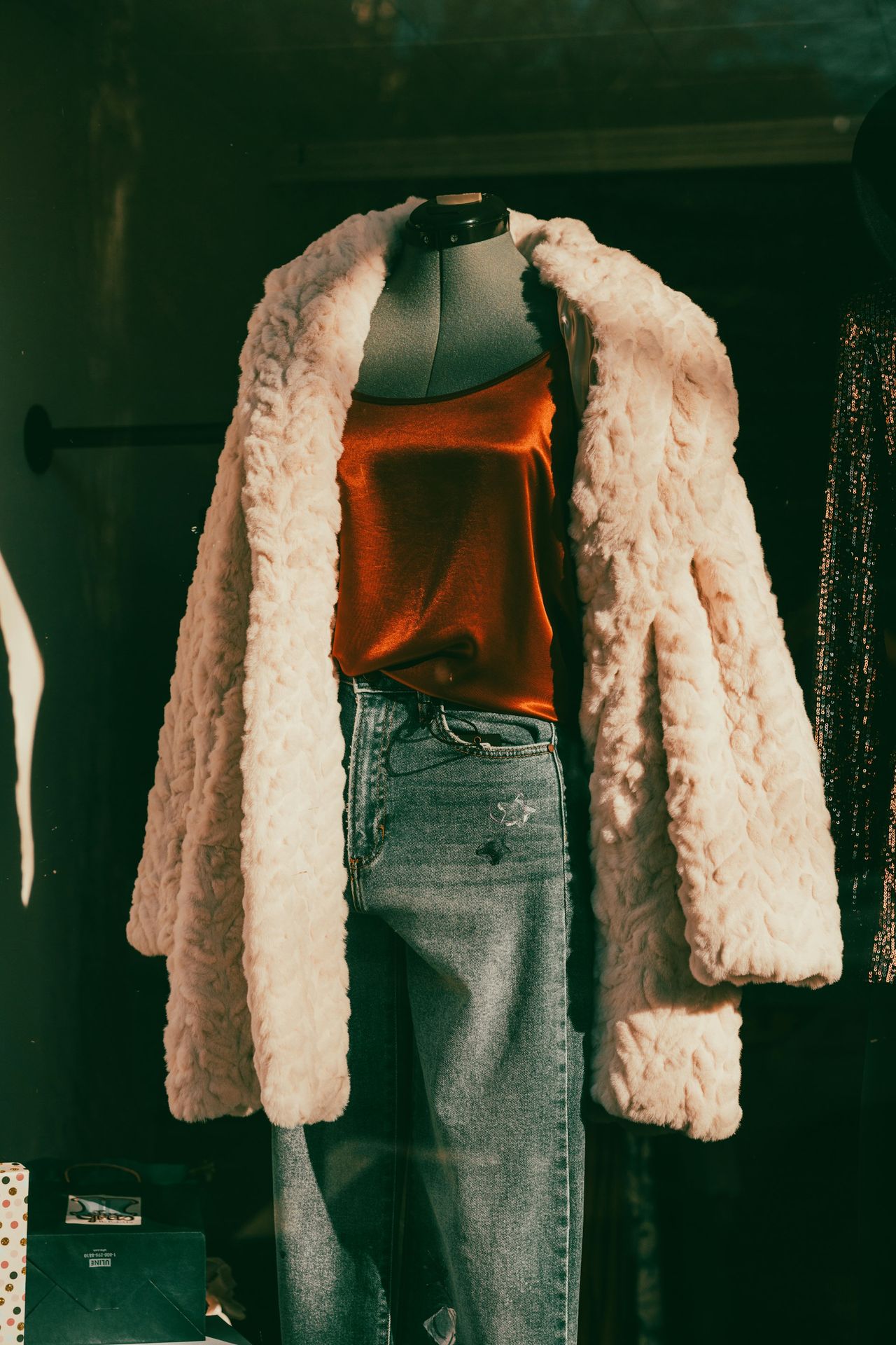 a woman's white fur coat on a mannequin